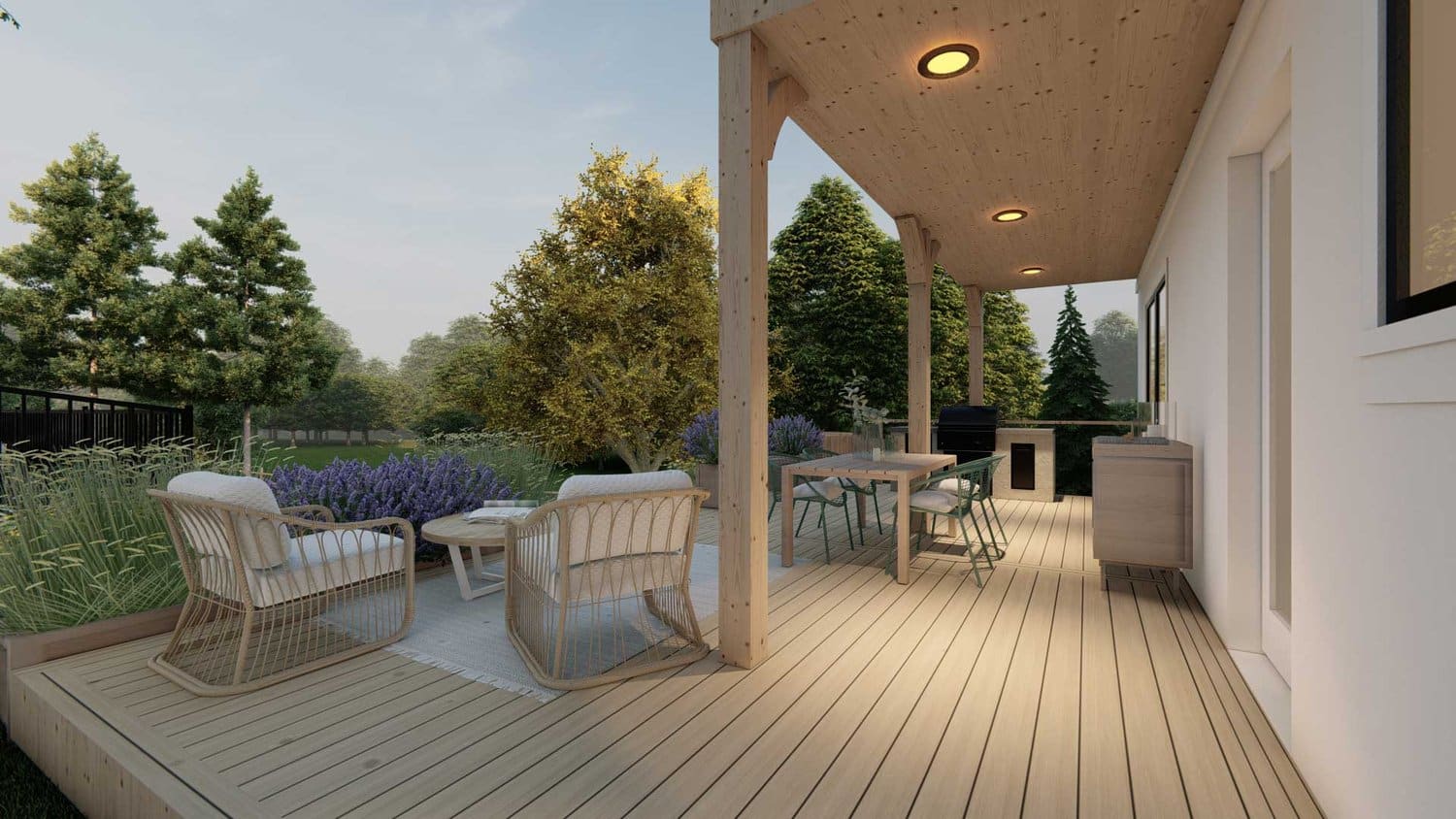 前院的长岛侧视图，带木甲板露台休息区和室外厨房，前面有植物和树木